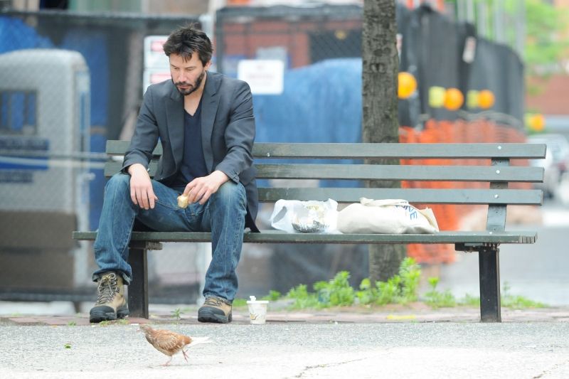Keanu Reeves has lunch on a park bench in Soho NYC
